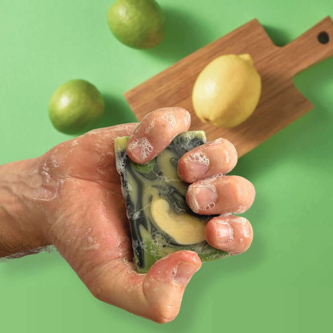 Wulf Body Bar - Hand holding a Zest Bright moisturising soap bar demonstrating its size, smooth surface, and rich citrus fragrance.