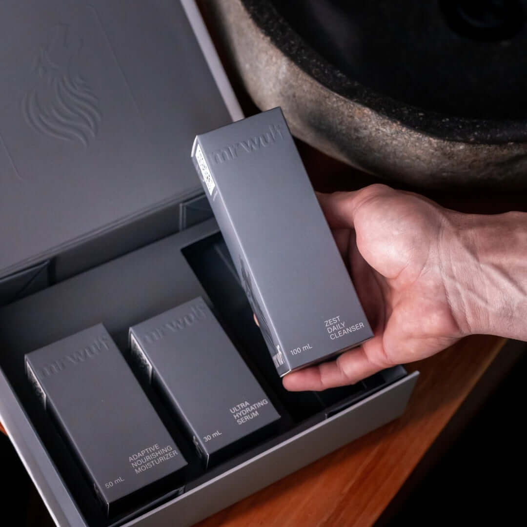 Zest Daily Face Cleanser for Men held in hand, part of a grooming product set.