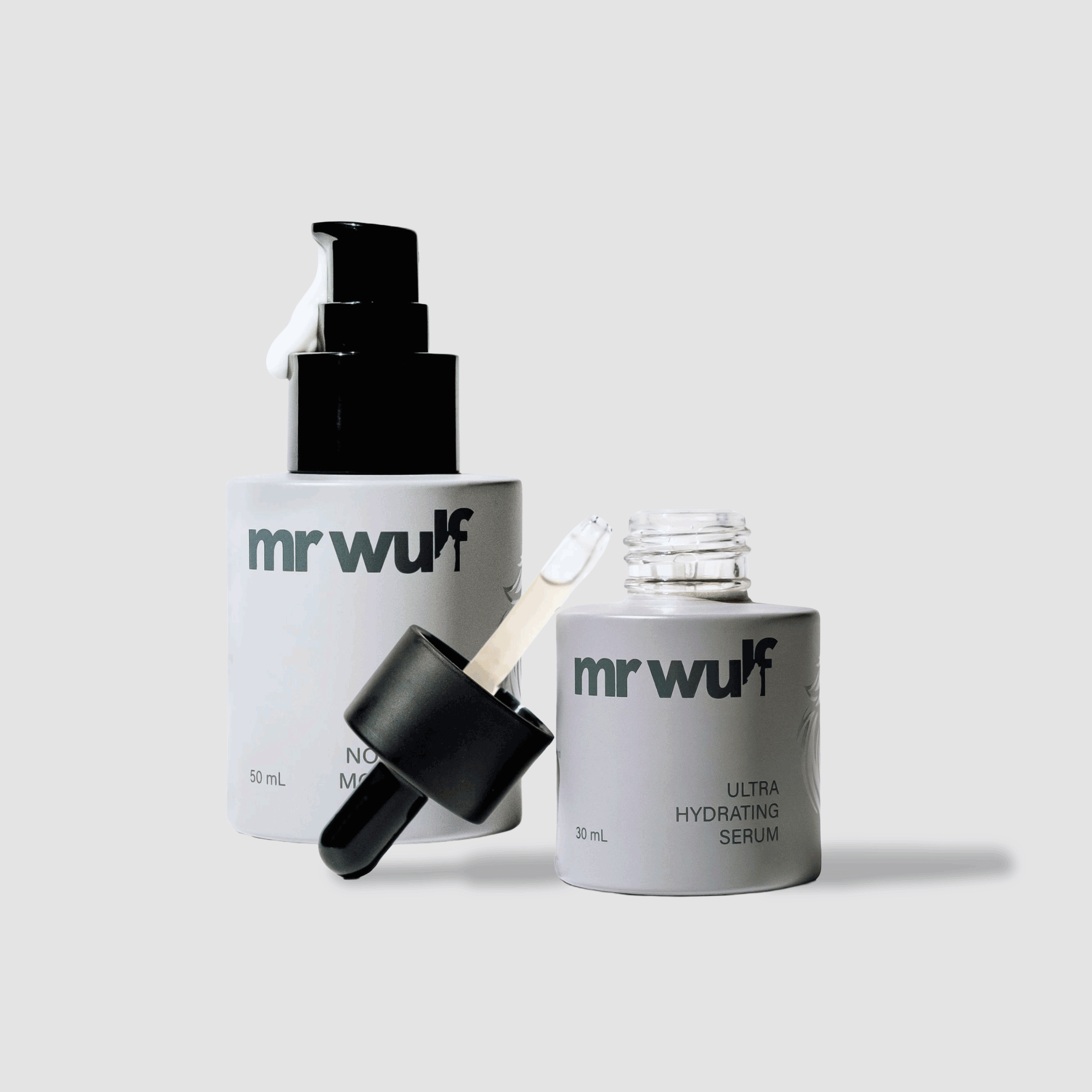 Men's skincare duo with serum and moisturizer bottles on white background