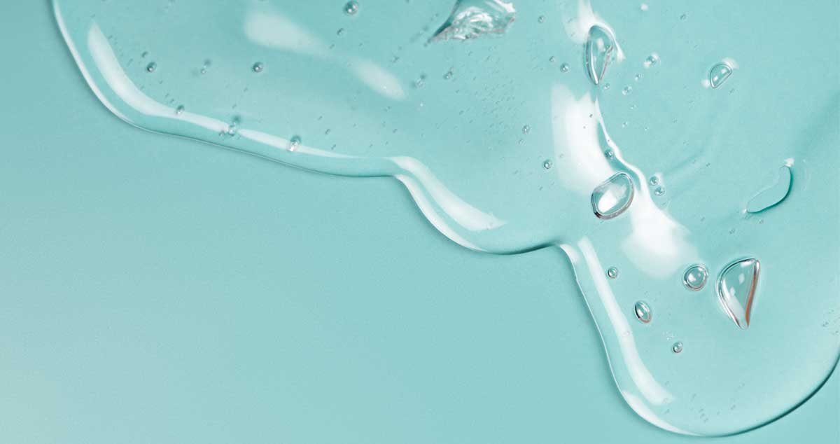 Hyaluronic Acid Blend The Ultimate Hydration Solution drops of clear gel on a blue background