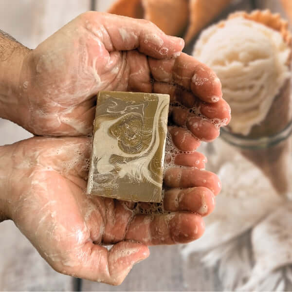 Hands holding vanilla mud bar