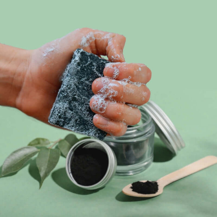 hand holding bar of charcoal mint soap