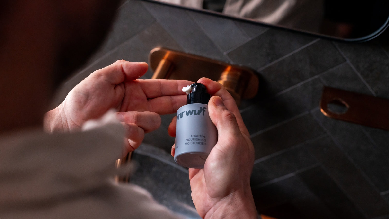 Man applying Adaptive Nourishing Moisturiser