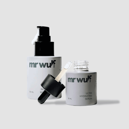 Men's skincare duo with serum and moisturizer bottles on white background